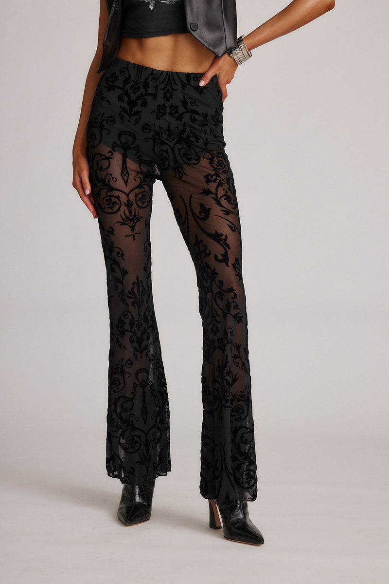 Detail shot of the Midnight Hour Black Velvet Burnout Flare Pants highlighting the flared elements.