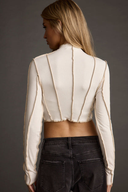 Full-length view of the white top showing the drape and movement.