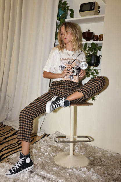 Close-up of the Bishop Tan Checkered Cropped Trousers showcasing the fabric texture and design details.