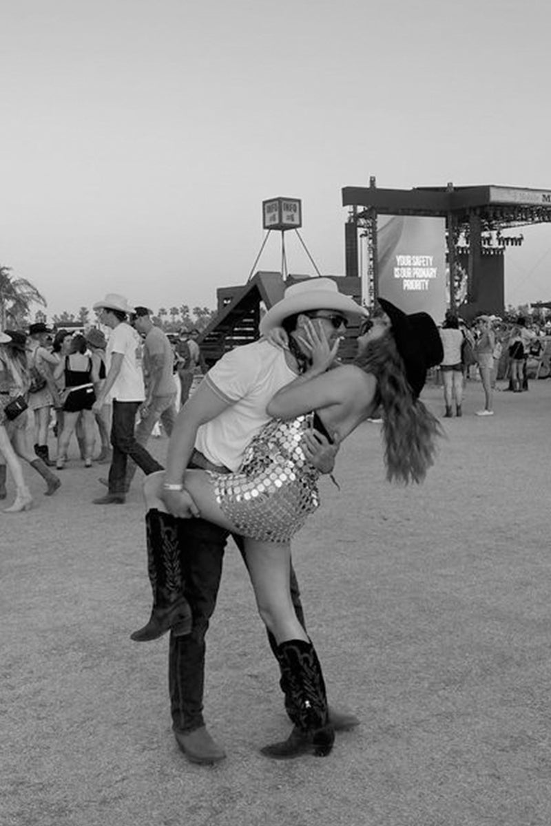 Silver sequin disco mini dress worn at a music festival, paired with cowboy hat and boots.