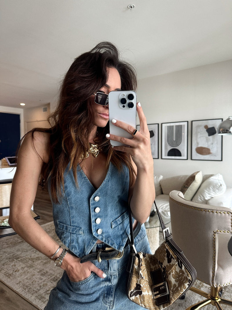 Blue denim vest with refined detailing and a flattering silhouette.