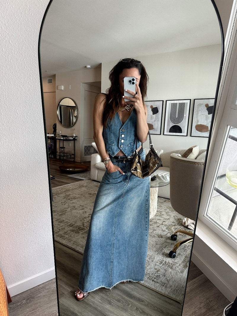 Full-length view of the blue vest showing the drape and movement.