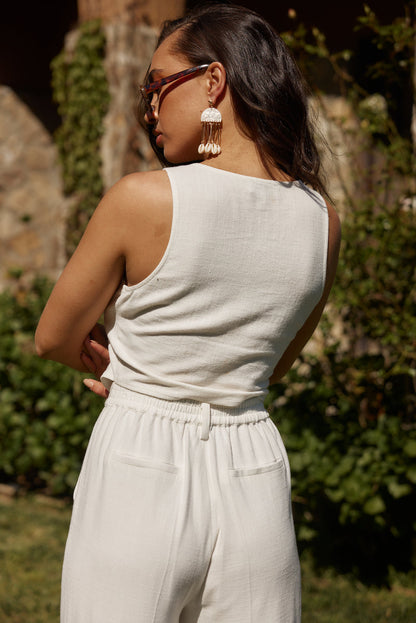 Back view of the white linen vest showing the silhouette and fit.