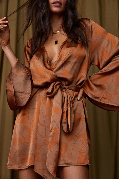 Rust dress with elegant accents, a gold fringe dress essential.