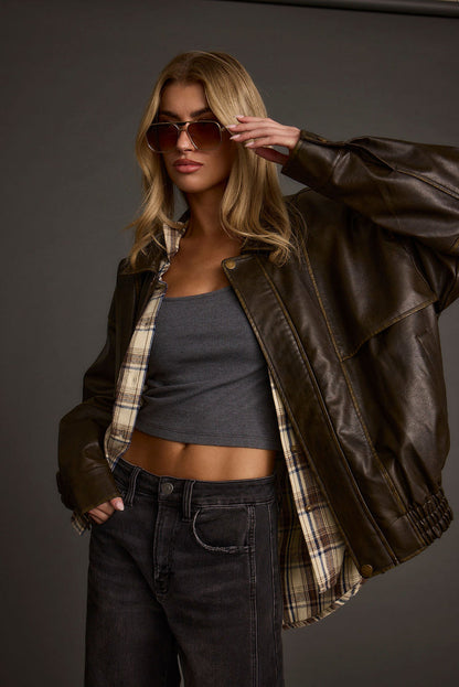 Full-length view of the brown jacket showing the drape and movement.