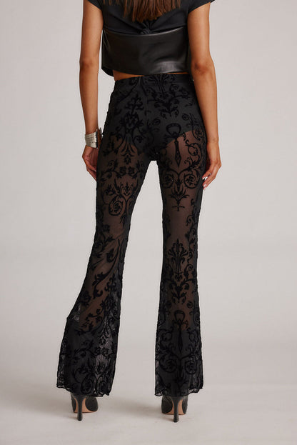 Close-up of the Midnight Hour Black Velvet Burnout Flare Pants showcasing the velvet texture and craftsmanship.