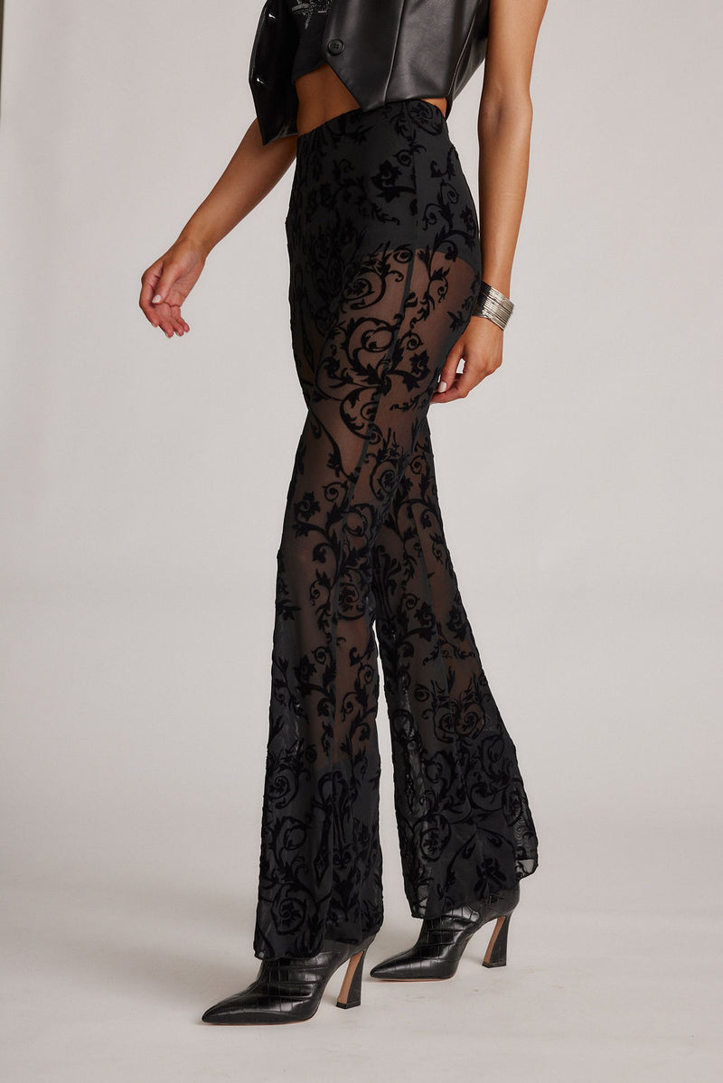 Midnight Hour Black Velvet Burnout Flare Pants styled in a complete look from an alternate angle.