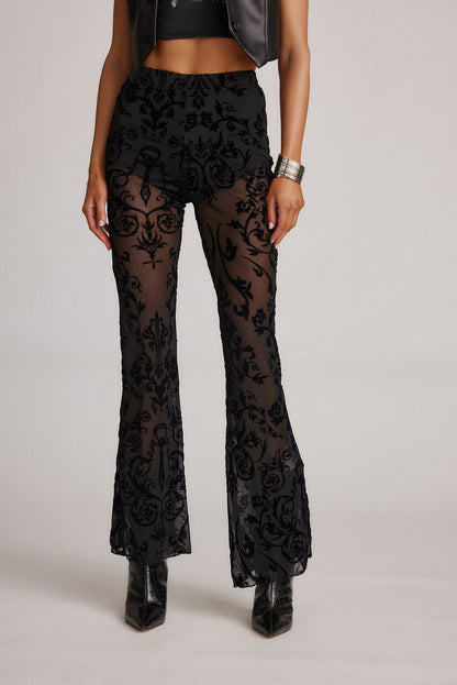 Full-length view of the black flare pants showing the drape and movement.
