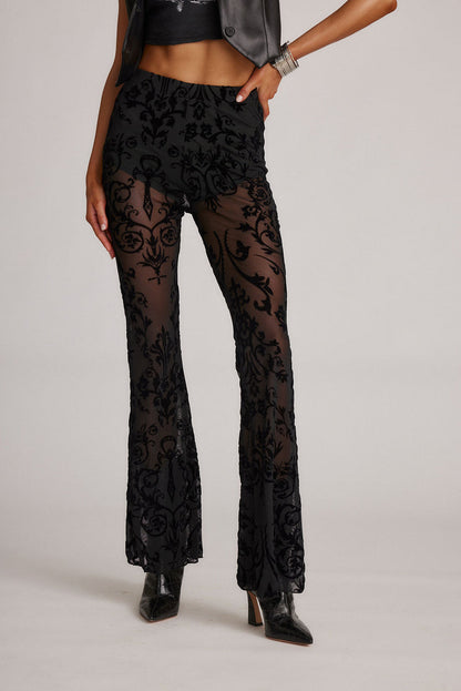 Detail shot of the Midnight Hour Black Velvet Burnout Flare Pants highlighting the flared elements.