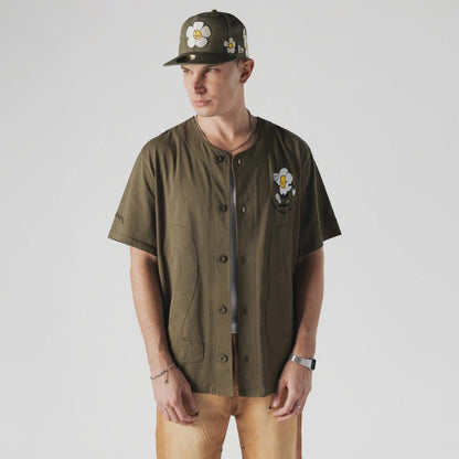 The Male model is wearing  New Era x Rodrigo Roji Flower Green Jersey 1