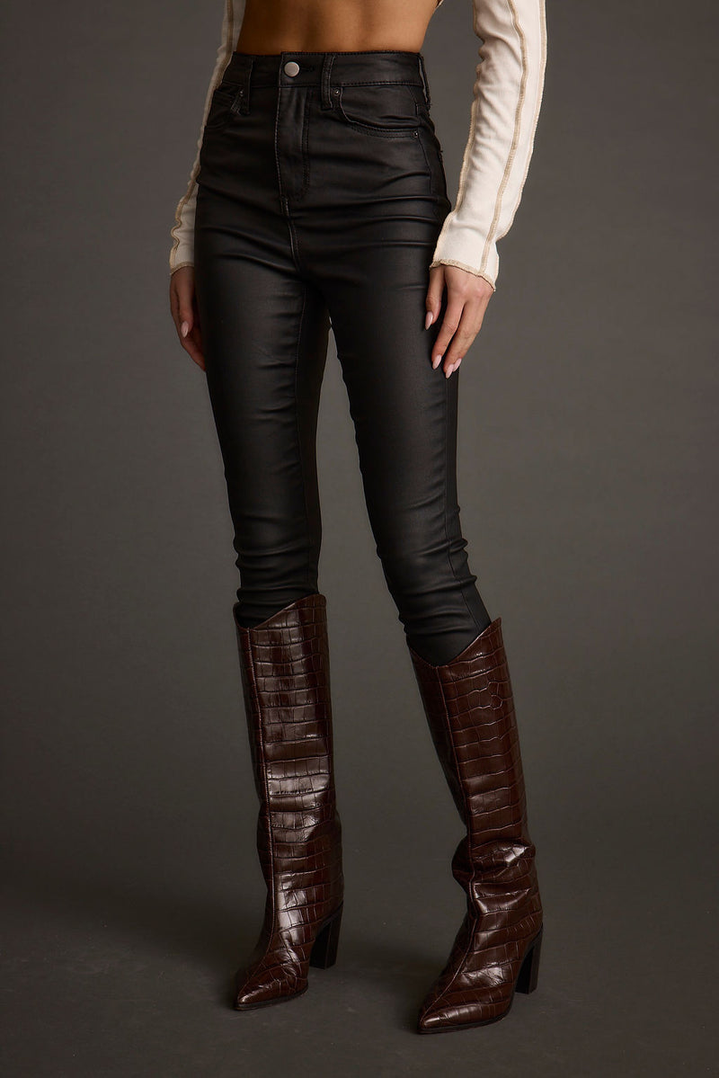 Black pants with elegant accents, a black lace pants standout.