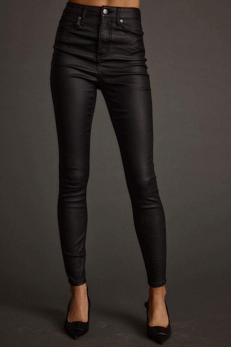Full-length view of the black pants showing the drape and movement.