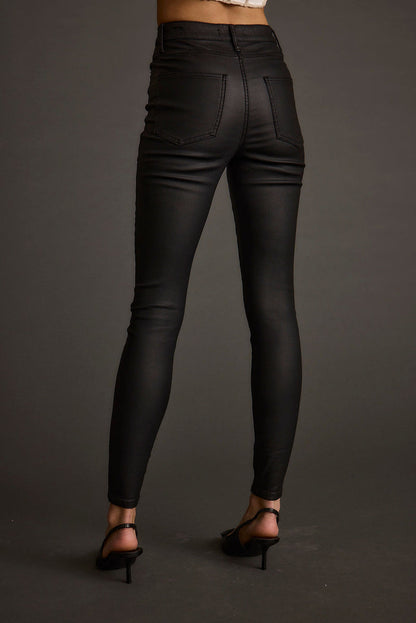 Lifestyle shot of the black pants styled for day-to-night versatility.