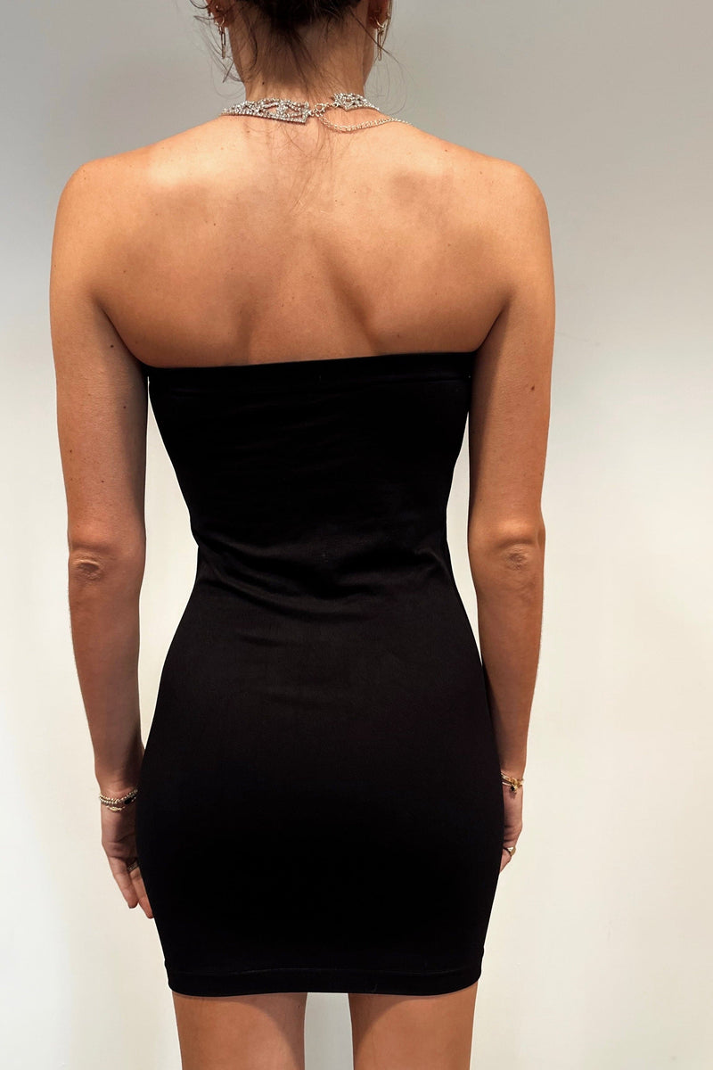 Back view of the black dress showing the silhouette and fit.