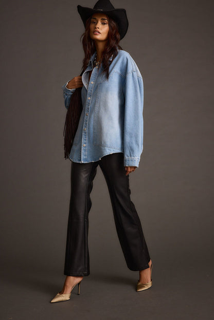 Back view of the black vegan leather and leather flare pants showing the silhouette and fit.