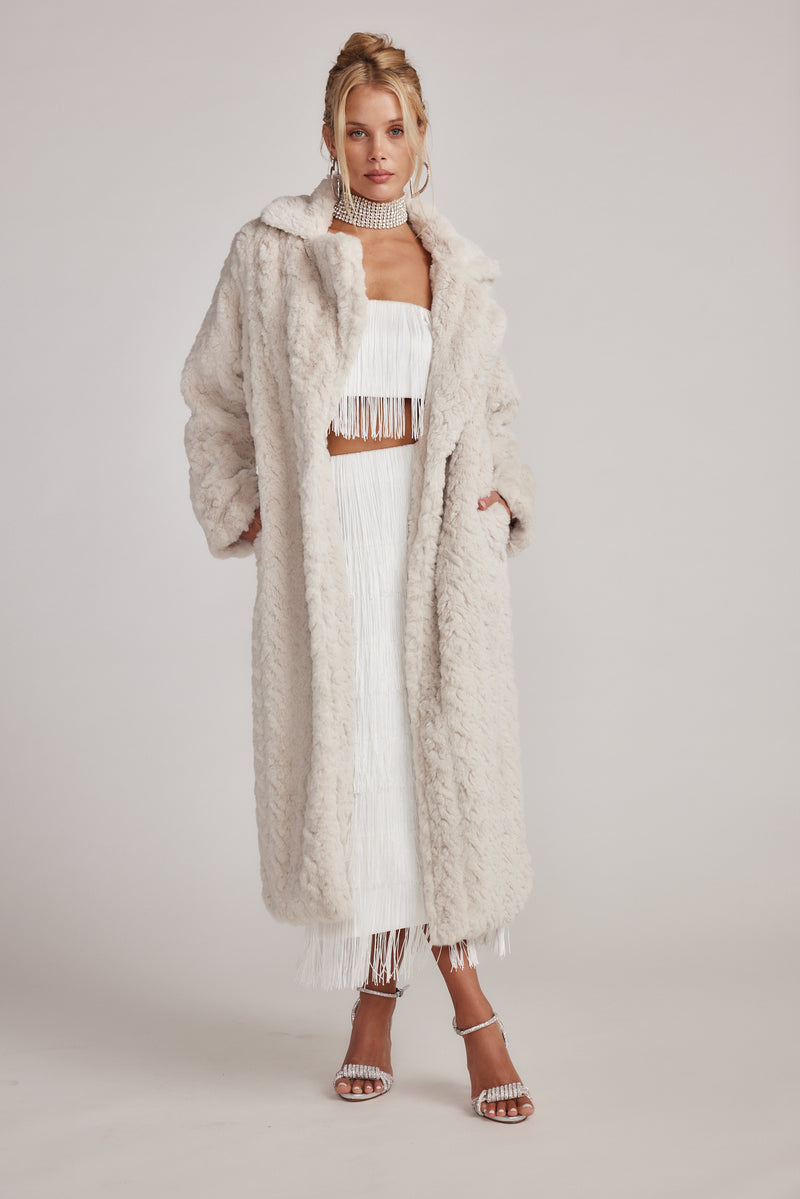 Cream jacket with refined detailing and a flattering silhouette.